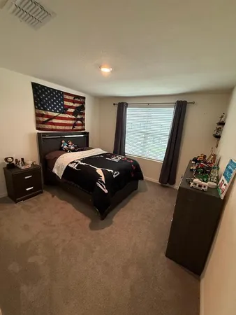 a bedroom with a bed and a window