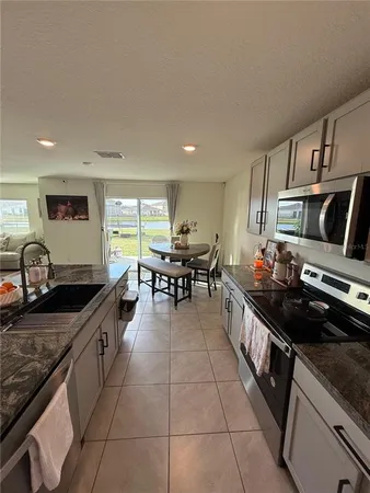a kitchen with stainless steel appliances a sink stove and cabinets