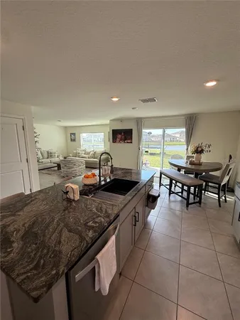 a view of a kitchen with kitchen island and a view of living room