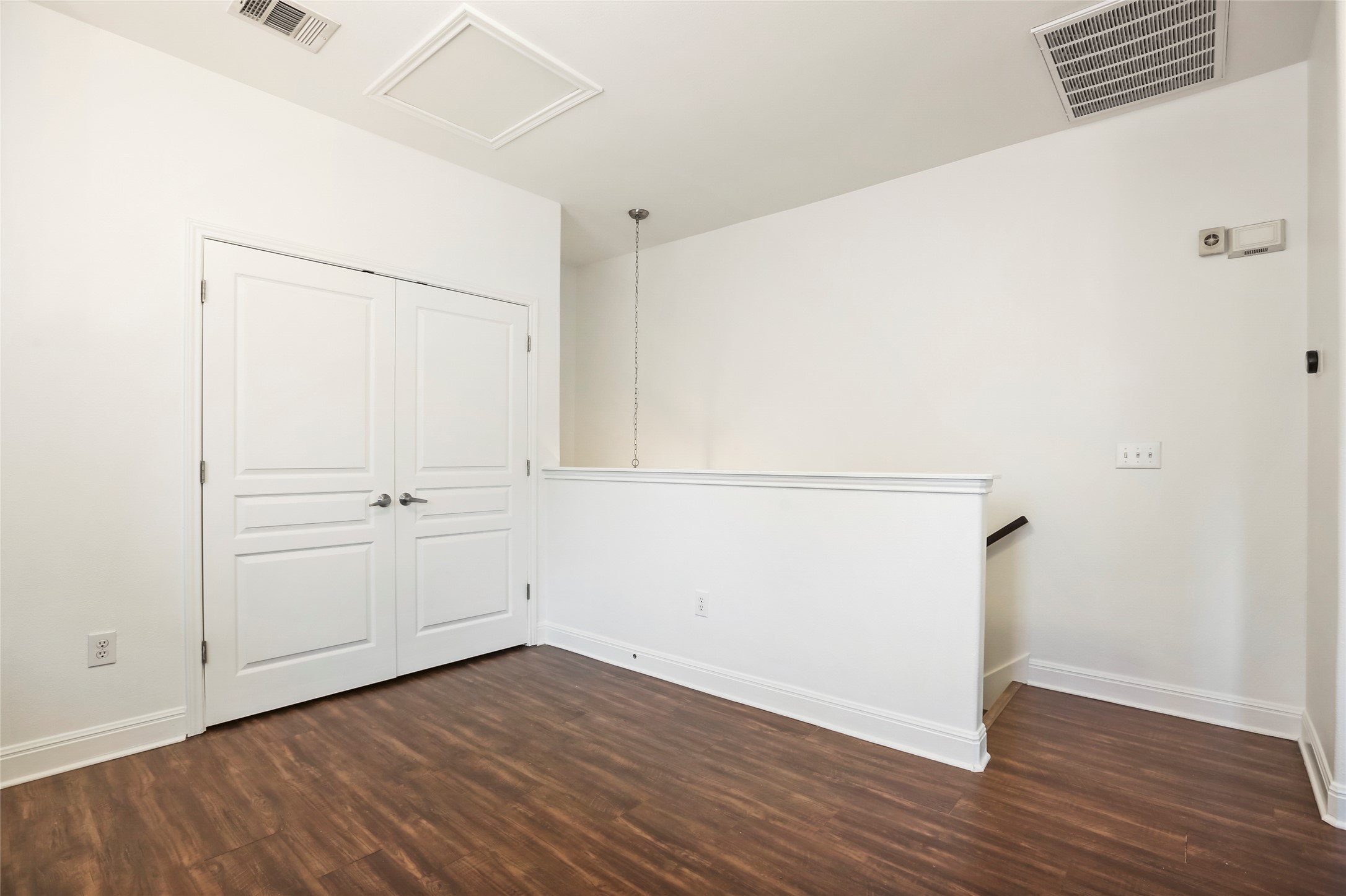 3406 Menchaca Road, Unit 19 Austin, TX 78704 - Photo 13 of 25 Rich wood flooring contrasts beautifully against crisp white walls in this upper level landing.