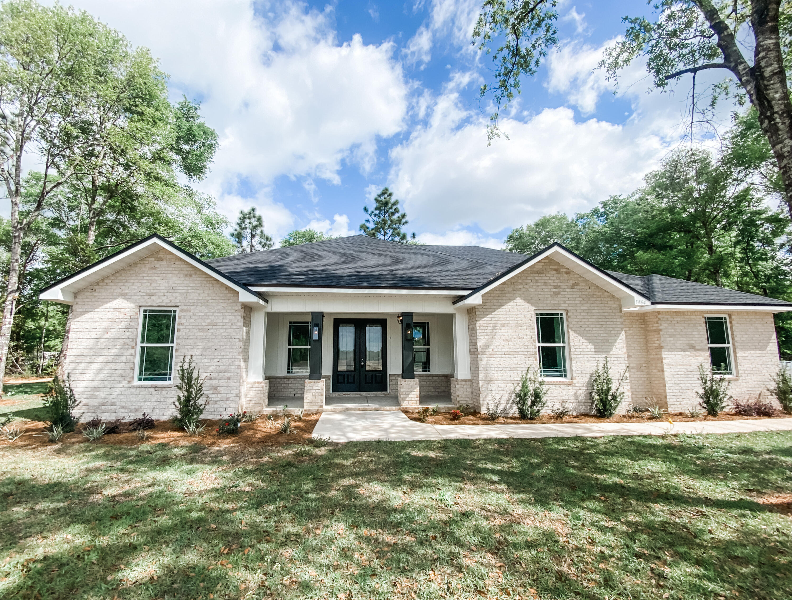 a front view of house with yard and green space