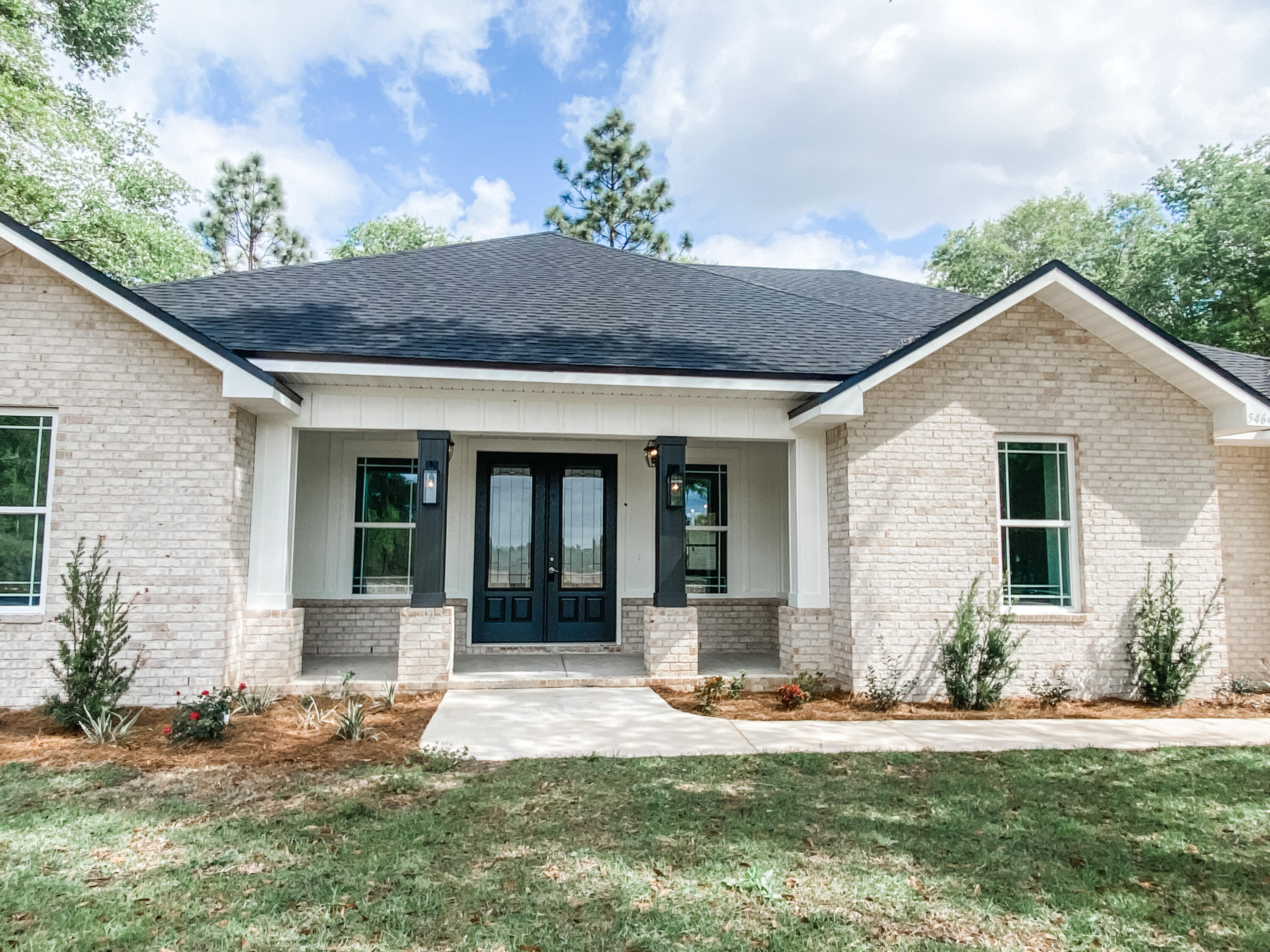 5464 Jenee Court Crestview, FL 32539 - Photo 2 of 10 a front view of a house with a yard and potted plants