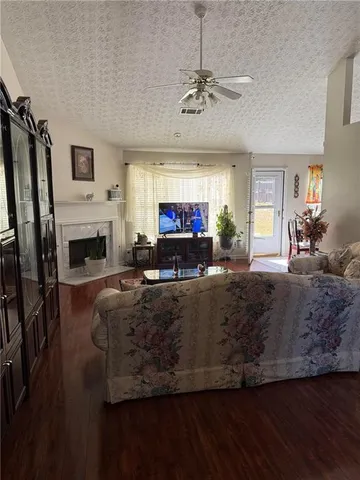 a living room with furniture a fireplace and a flat screen tv