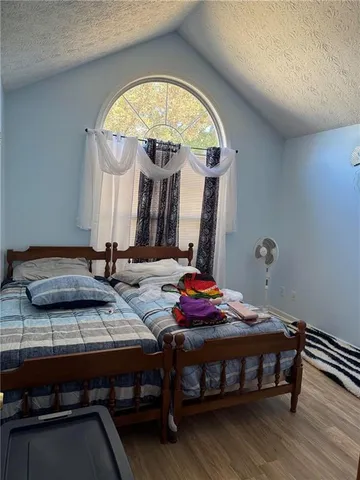 a bedroom with bed and a mirror