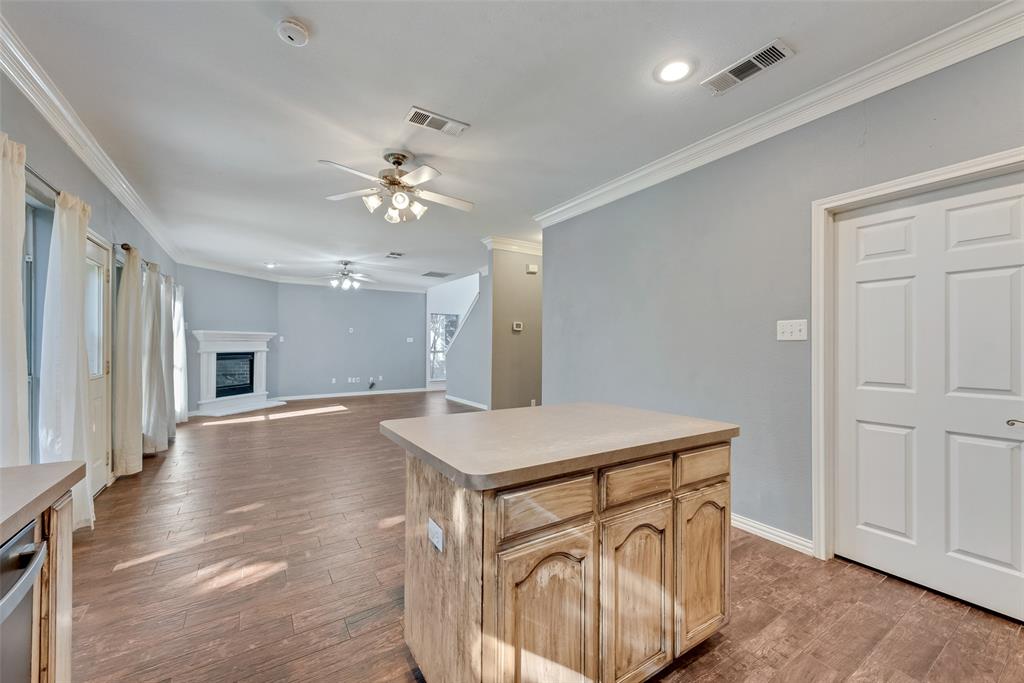 2836 Morning Star Drive Fort Worth, TX 76131 - Photo 11 of 27 a hall with kitchen island hardwood floor and a ceiling fan