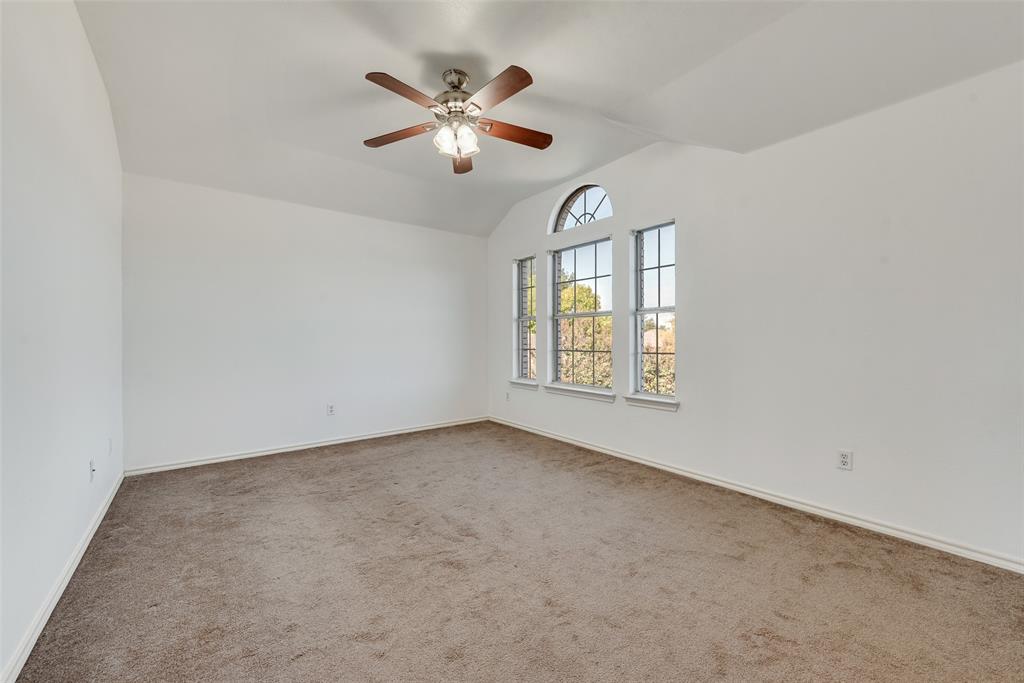 2836 Morning Star Drive Fort Worth, TX 76131 - Photo 21 of 27 an empty room with windows and chandelier fan