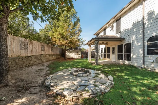 a view of a house with backyard and sitting area