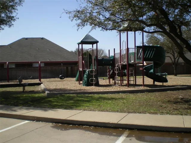 a view of a park with swings and slides