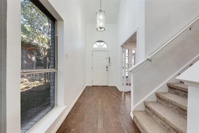 a view of entryway and hall with wooden floor