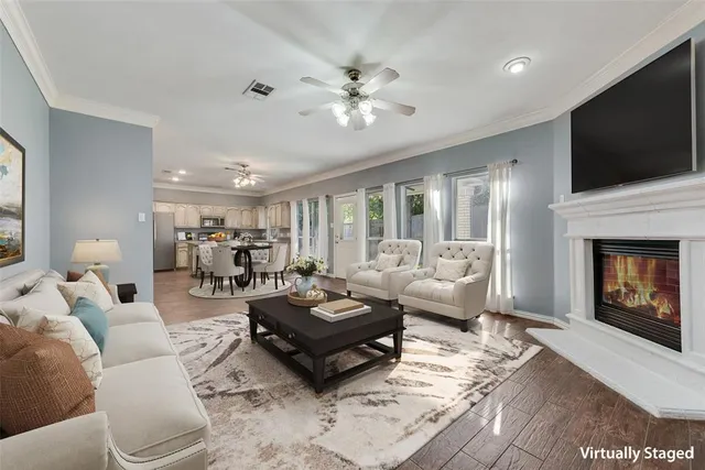 a living room with furniture a flat screen tv and a fireplace