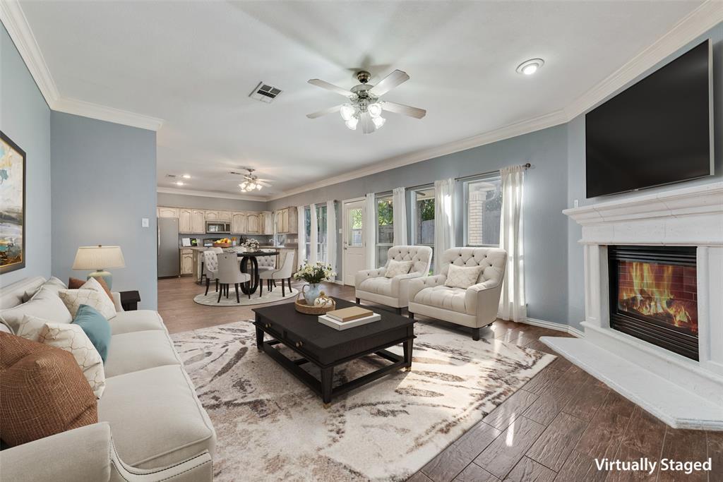 2836 Morning Star Drive Fort Worth, TX 76131 - Photo 6 of 27 a living room with furniture a flat screen tv and a fireplace