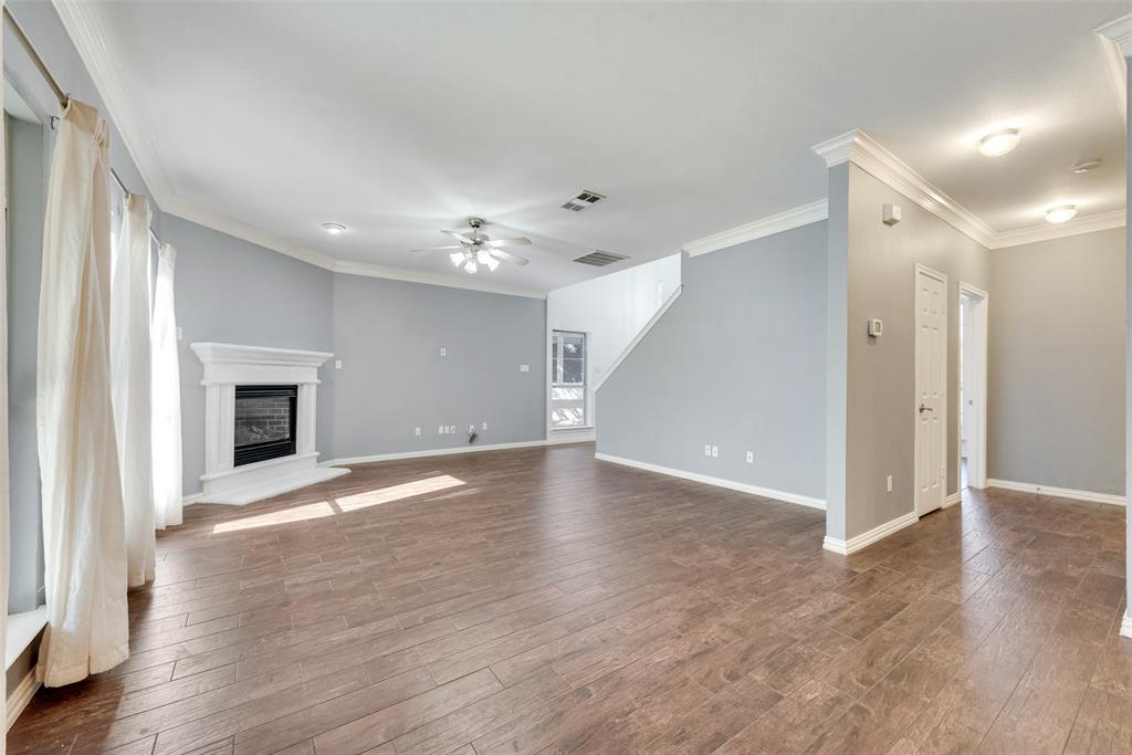 2836 Morning Star Drive Fort Worth, TX 76131 - Photo 7 of 27 a view of an empty room with wooden floor and a window
