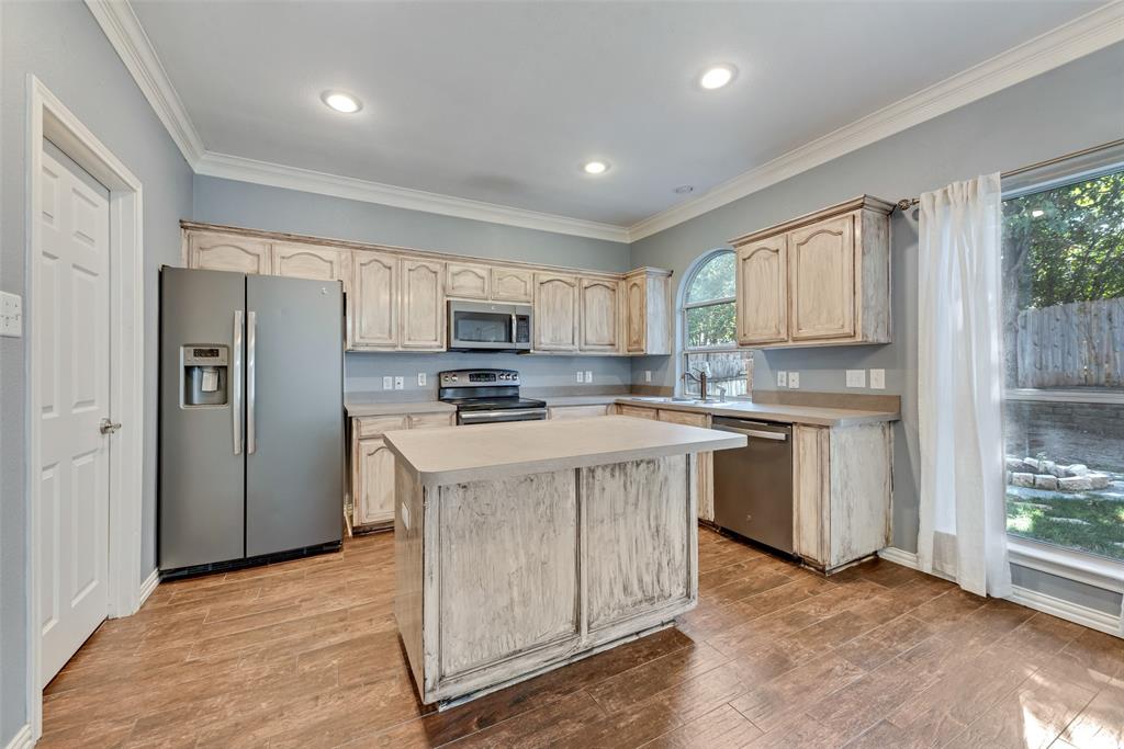 2836 Morning Star Drive Fort Worth, TX 76131 - Photo 9 of 27 a kitchen with stainless steel appliances granite countertop a stove top oven a refrigerator a sink and a microwave