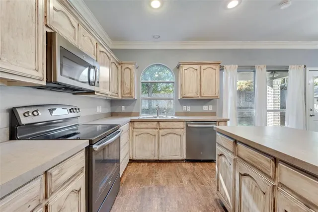 a kitchen with stainless steel appliances granite countertop a stove and cabinets