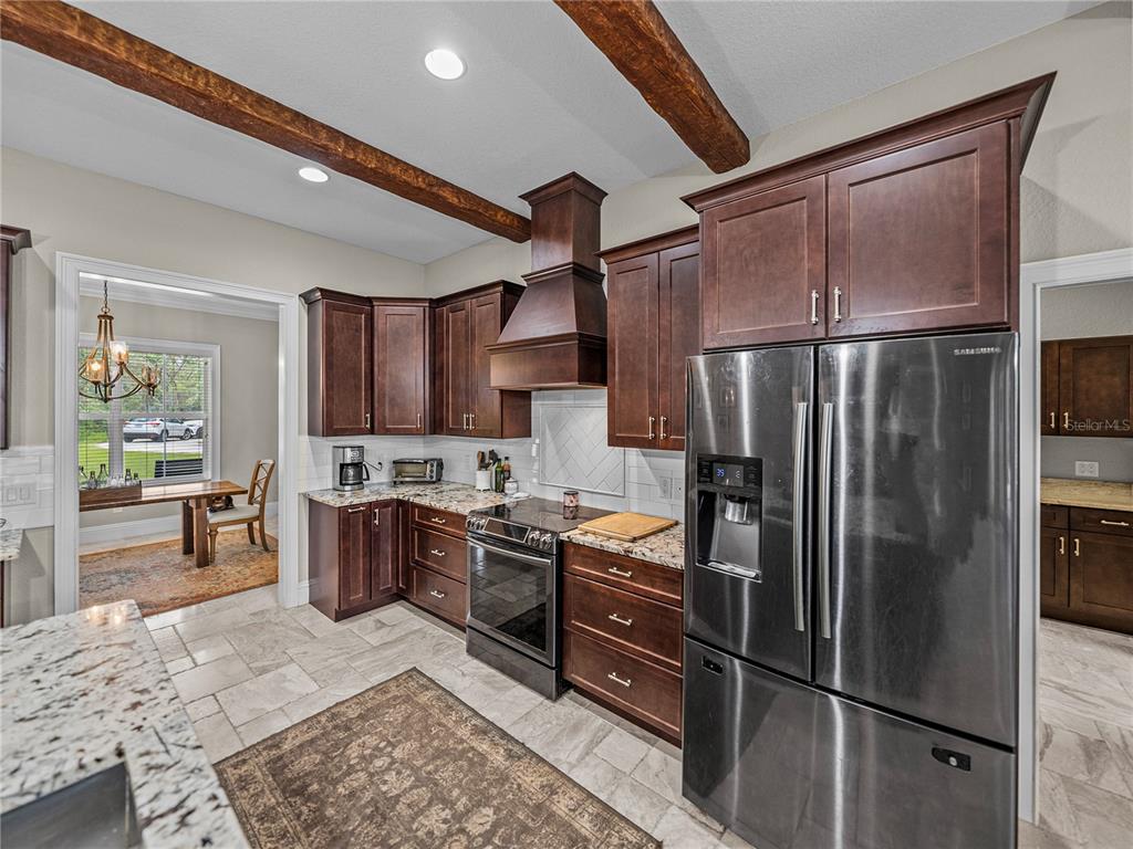 3985 Mammoth Grove Road Lake Wales, FL 33898 - Photo 17 of 97 a kitchen with stainless steel appliances granite countertop a refrigerator stove and sink