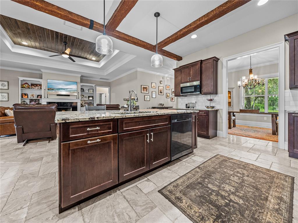3985 Mammoth Grove Road Lake Wales, FL 33898 - Photo 18 of 97 a kitchen with a sink and wooden cabinets