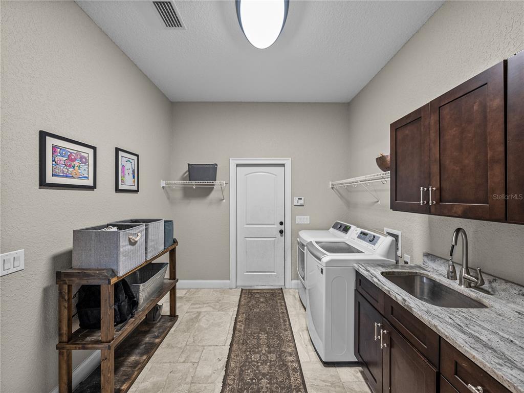 3985 Mammoth Grove Road Lake Wales, FL 33898 - Photo 30 of 97 a kitchen with a sink stove and refrigerator