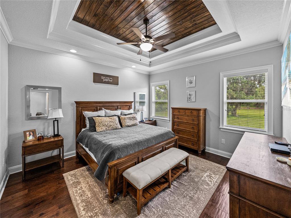 3985 Mammoth Grove Road Lake Wales, FL 33898 - Photo 36 of 97 a bedroom with a bed a dresser and potted plant on the dresser