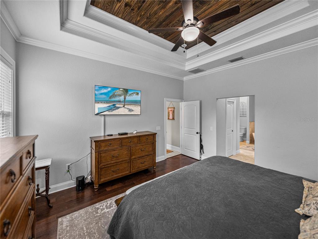 3985 Mammoth Grove Road Lake Wales, FL 33898 - Photo 38 of 97 a bedroom with a bed and a chandelier