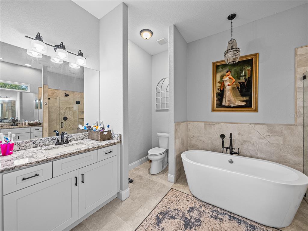 3985 Mammoth Grove Road Lake Wales, FL 33898 - Photo 42 of 97 a spacious bathroom with a tub sink and mirror