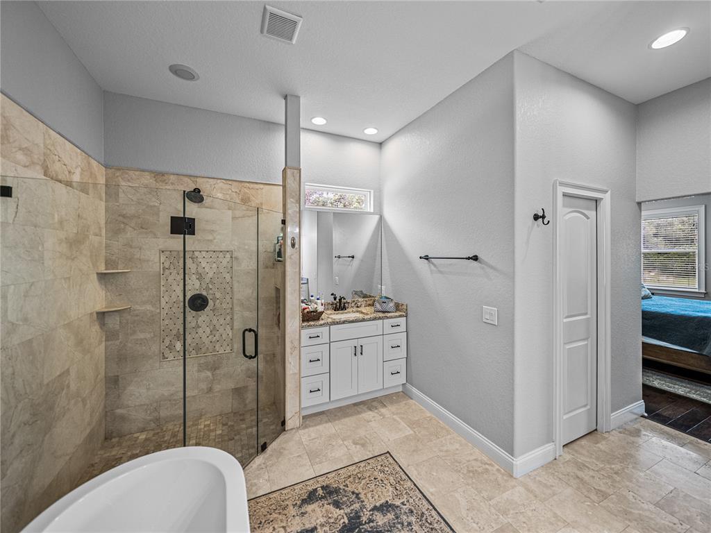 3985 Mammoth Grove Road Lake Wales, FL 33898 - Photo 45 of 97 a spacious bathroom with a granite countertop sink a toilet and shower