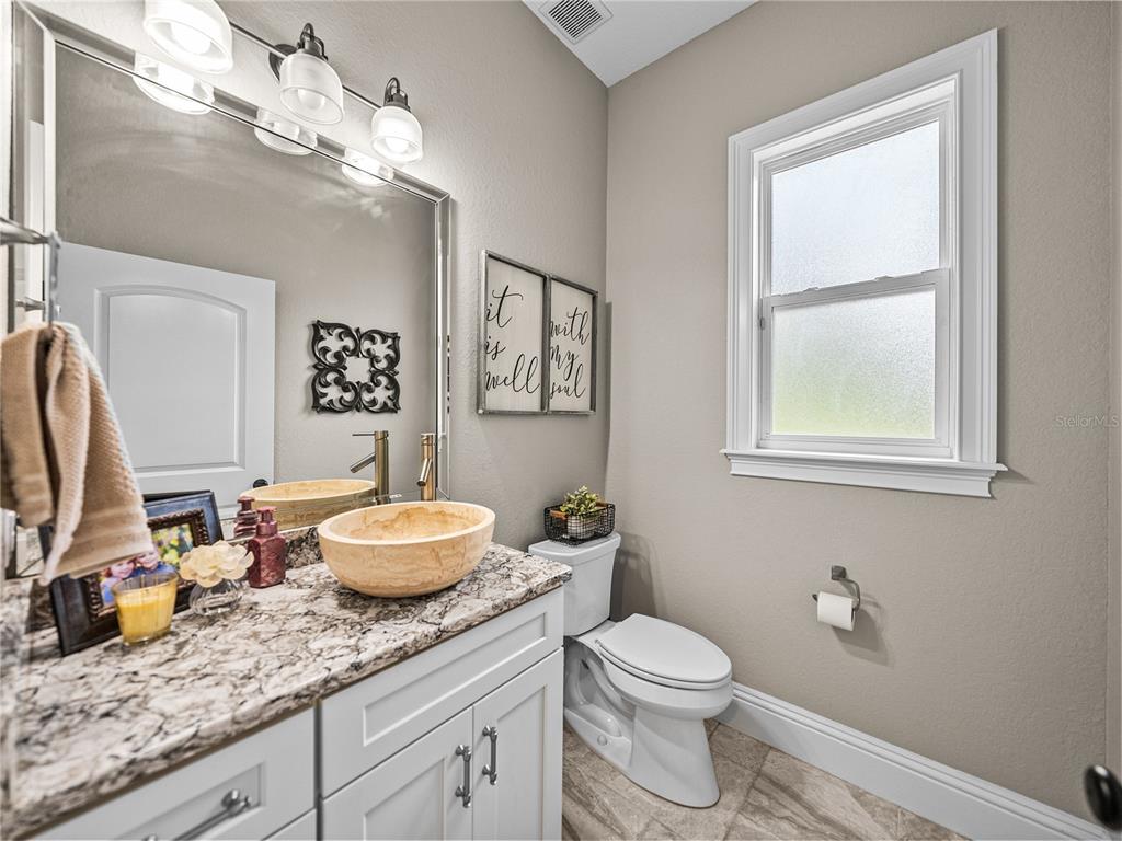 3985 Mammoth Grove Road Lake Wales, FL 33898 - Photo 48 of 97 a bathroom with a granite countertop toilet sink and mirror
