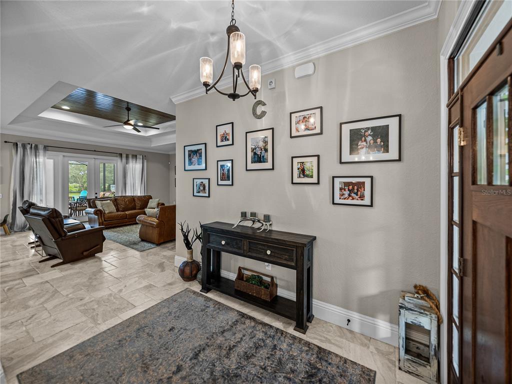 3985 Mammoth Grove Road Lake Wales, FL 33898 - Photo 6 of 97 a living room with furniture a chandelier and a flat screen tv