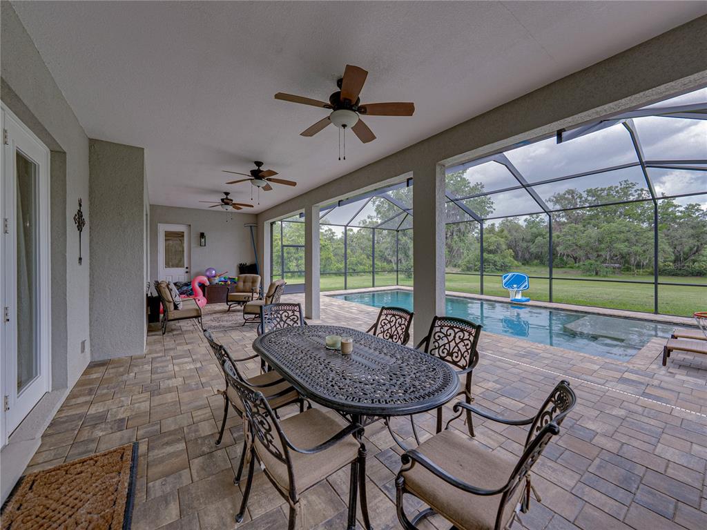 3985 Mammoth Grove Road Lake Wales, FL 33898 - Photo 65 of 97 a view of a dining room with furniture wooden floor and a chandelier