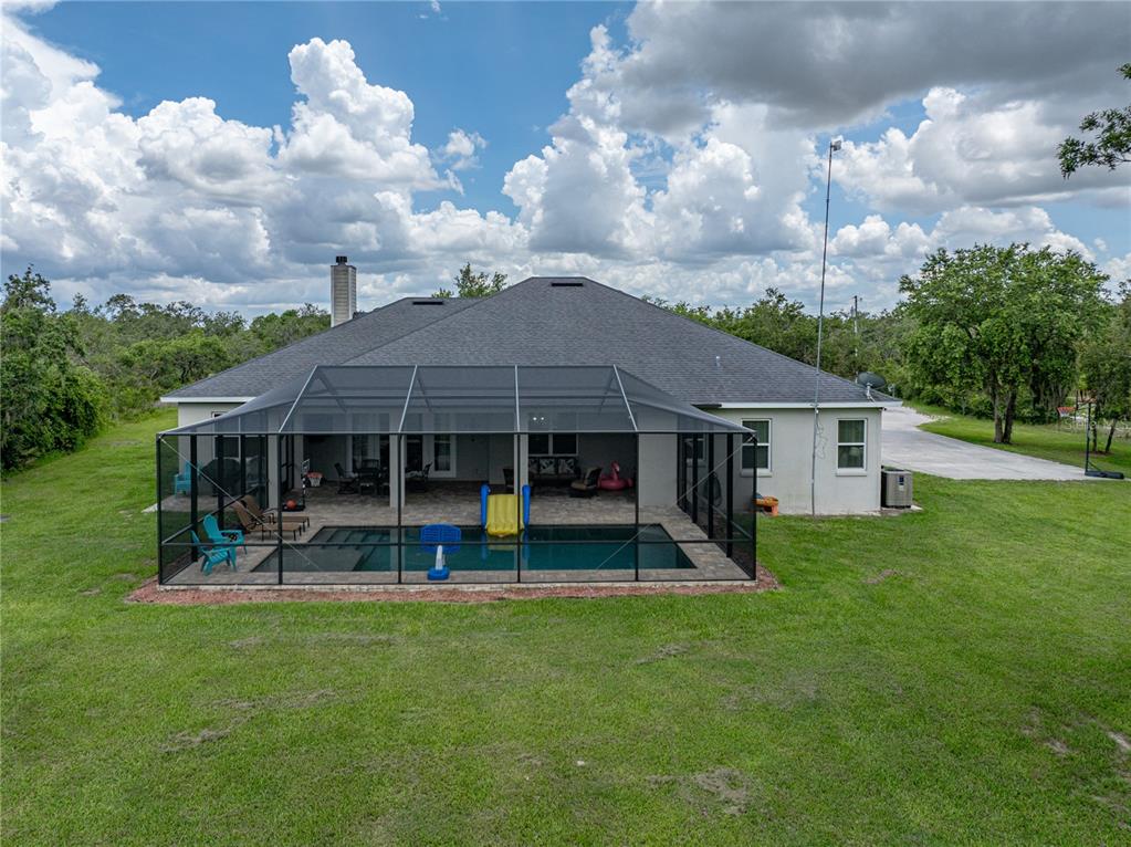 3985 Mammoth Grove Road Lake Wales, FL 33898 - Photo 76 of 97 a view of a house with a backyard