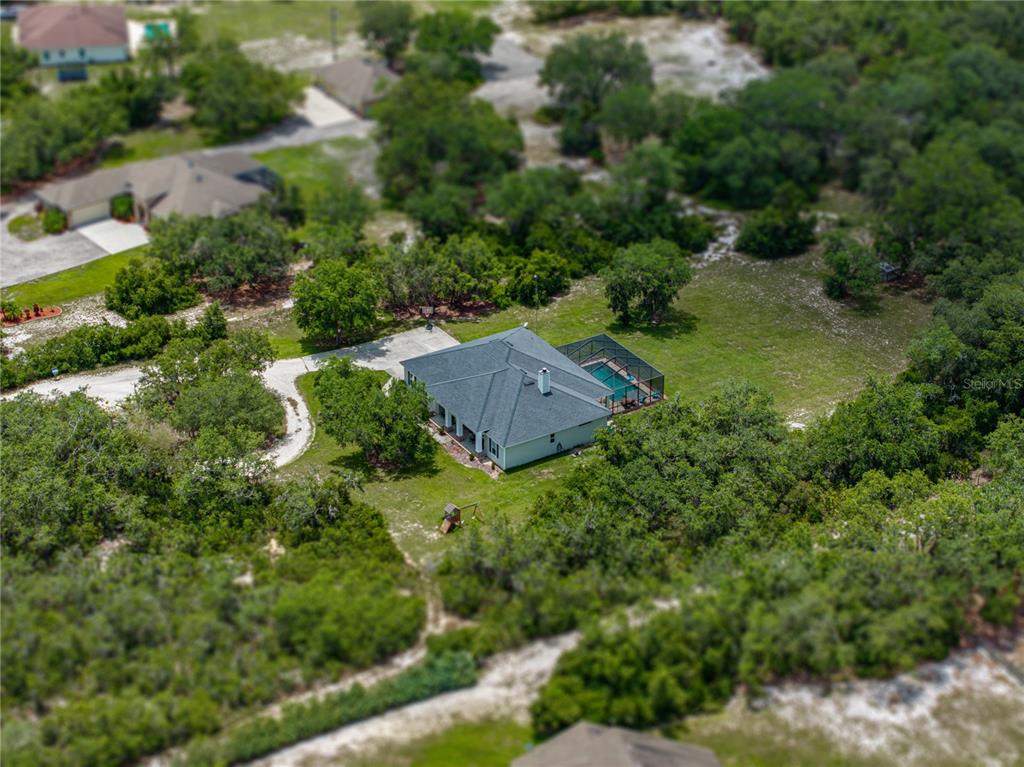 3985 Mammoth Grove Road Lake Wales, FL 33898 - Photo 91 of 97 an aerial view of residential house with outdoor space and trees all around