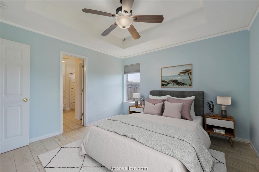 501 Riggs Street Brenham, TX 77833 - Photo 10 of 20 a bedroom with a bed and a chandelier