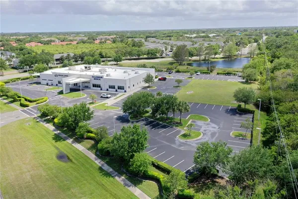 an aerial view of residential houses with outdoor space and river