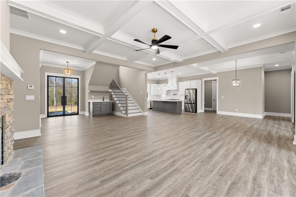 5697 Ball Ground Road Ball Ground, GA 30107 - Photo 12 of 63 a view of a livingroom with hardwood floor and a ceiling fan