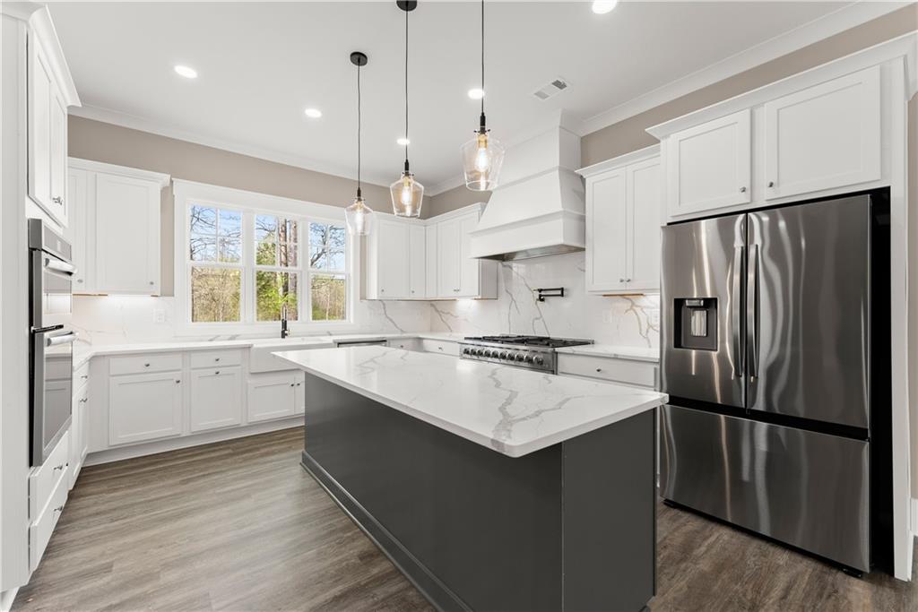 5697 Ball Ground Road Ball Ground, GA 30107 - Photo 14 of 63 a kitchen with white cabinets and stainless steel appliances