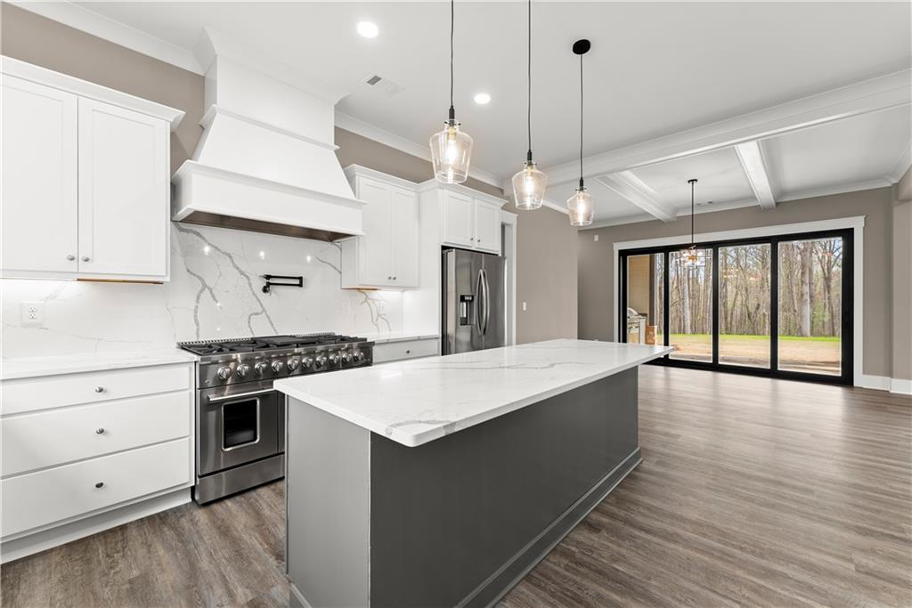 5697 Ball Ground Road Ball Ground, GA 30107 - Photo 15 of 63 a large kitchen with stainless steel appliances a large counter space a stove and a window