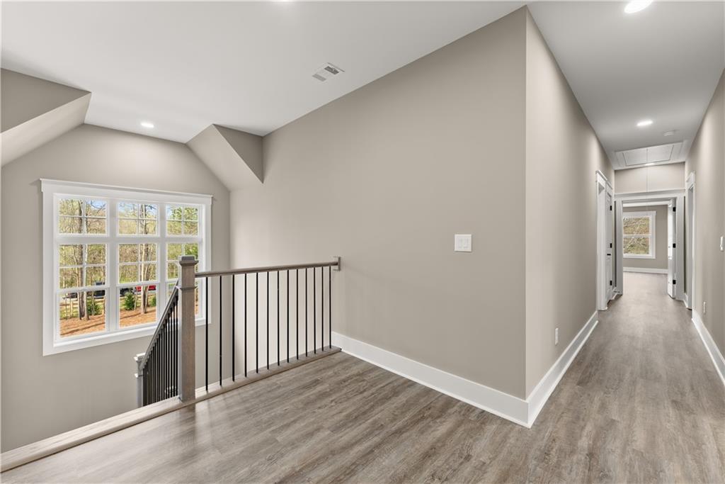 5697 Ball Ground Road Ball Ground, GA 30107 - Photo 19 of 63 a view of a hallway with wooden floor and a window