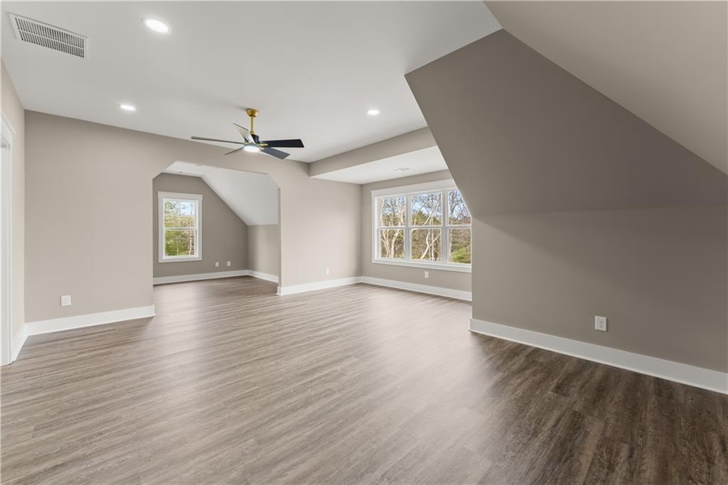 5697 Ball Ground Road Ball Ground, GA 30107 - Photo 26 of 63 an empty room with wooden floor and windows