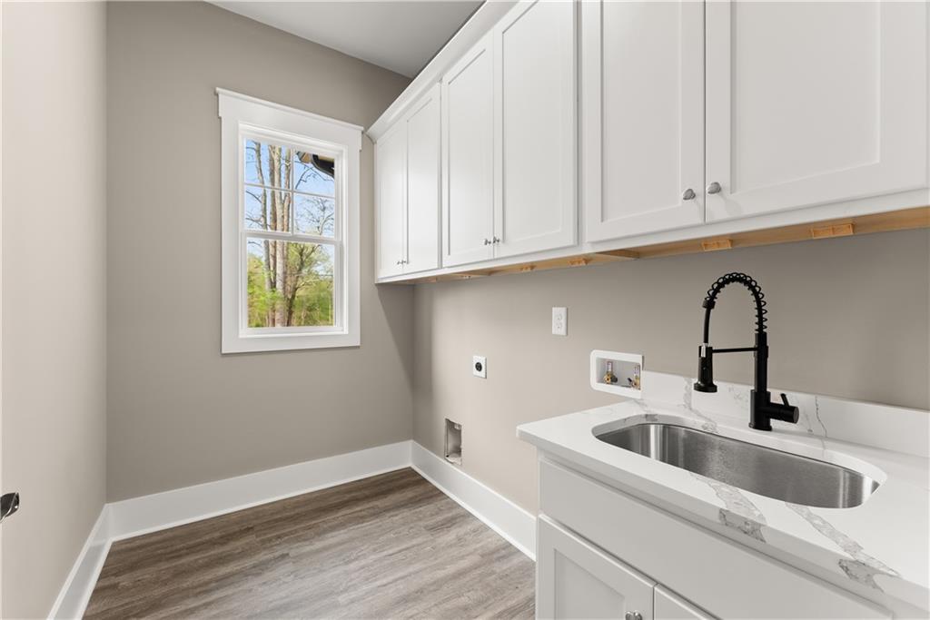 5697 Ball Ground Road Ball Ground, GA 30107 - Photo 29 of 63 a kitchen with stainless steel appliances granite countertop a sink a window and cabinets