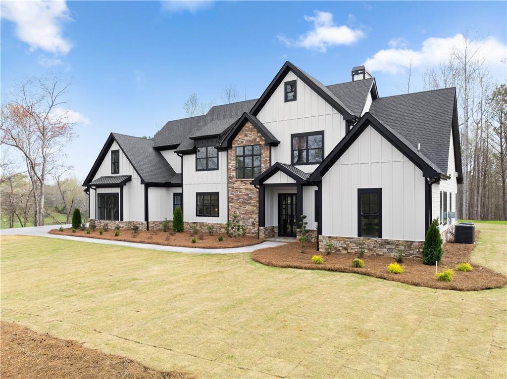 5697 Ball Ground Road Ball Ground, GA 30107 - Photo 3 of 63 a front view of a house with a yard