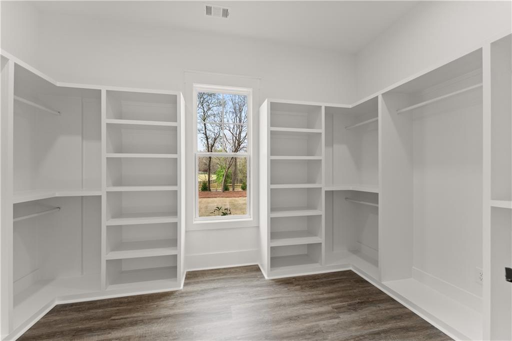 5697 Ball Ground Road Ball Ground, GA 30107 - Photo 33 of 63 a view of walk in closet with empty racks