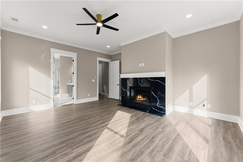 5697 Ball Ground Road Ball Ground, GA 30107 - Photo 38 of 63 a view of empty room with wooden floor and fireplace