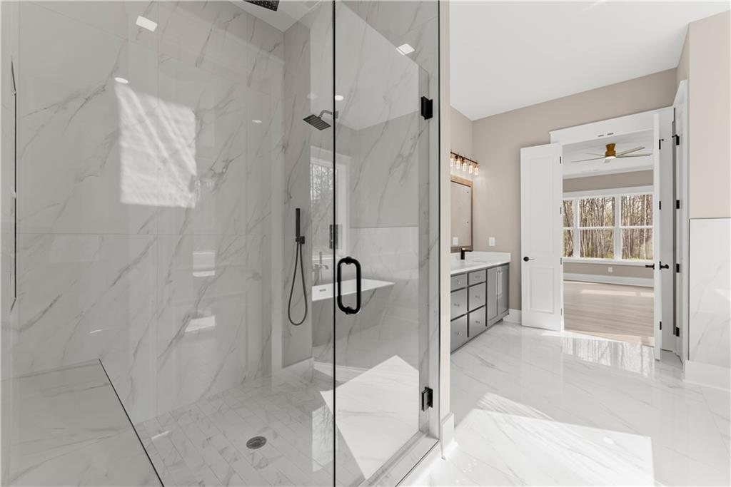 5697 Ball Ground Road Ball Ground, GA 30107 - Photo 39 of 63 a bathroom with a glass shower door and a glass door shower