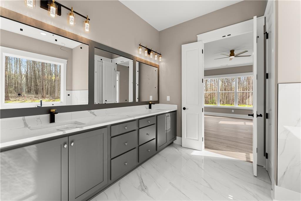 5697 Ball Ground Road Ball Ground, GA 30107 - Photo 40 of 63 a spacious bathroom with a granite countertop sink mirror and double
