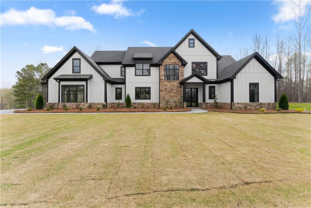 5697 Ball Ground Road Ball Ground, GA 30107 - Photo 4 of 63 a front view of a house with a yard