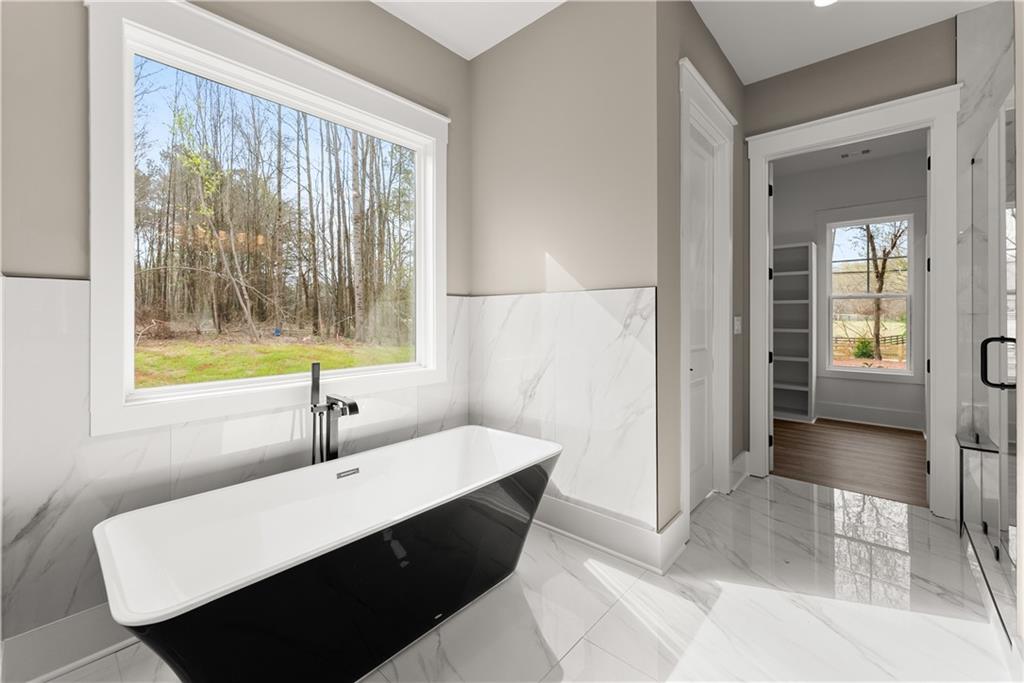 5697 Ball Ground Road Ball Ground, GA 30107 - Photo 43 of 63 a room with a bed and a window