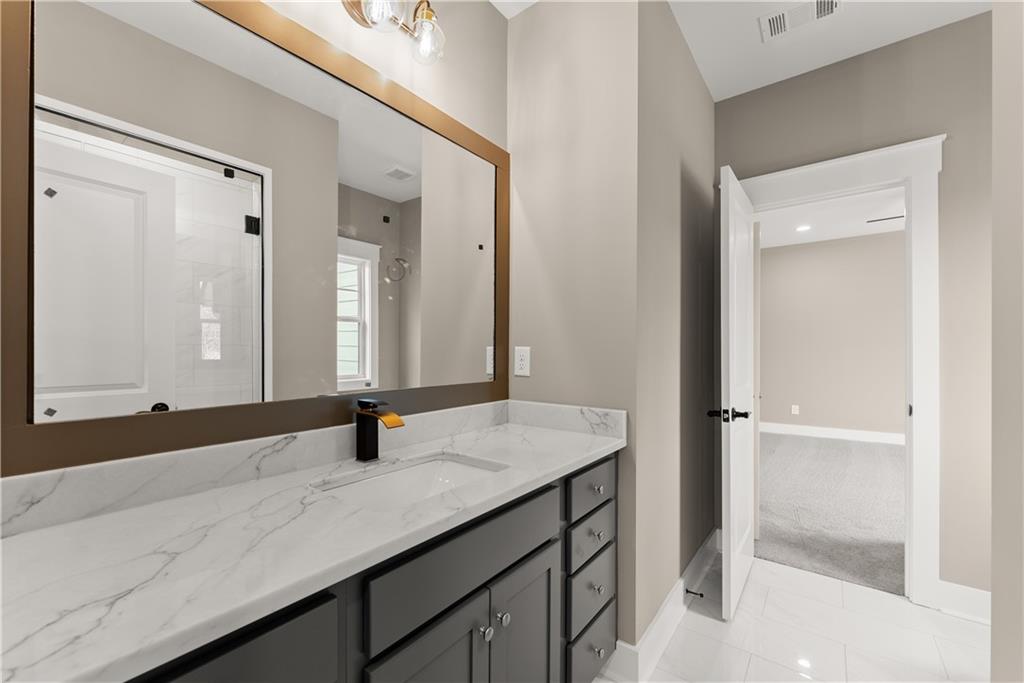 5697 Ball Ground Road Ball Ground, GA 30107 - Photo 45 of 63 a bathroom with a sink and a mirror