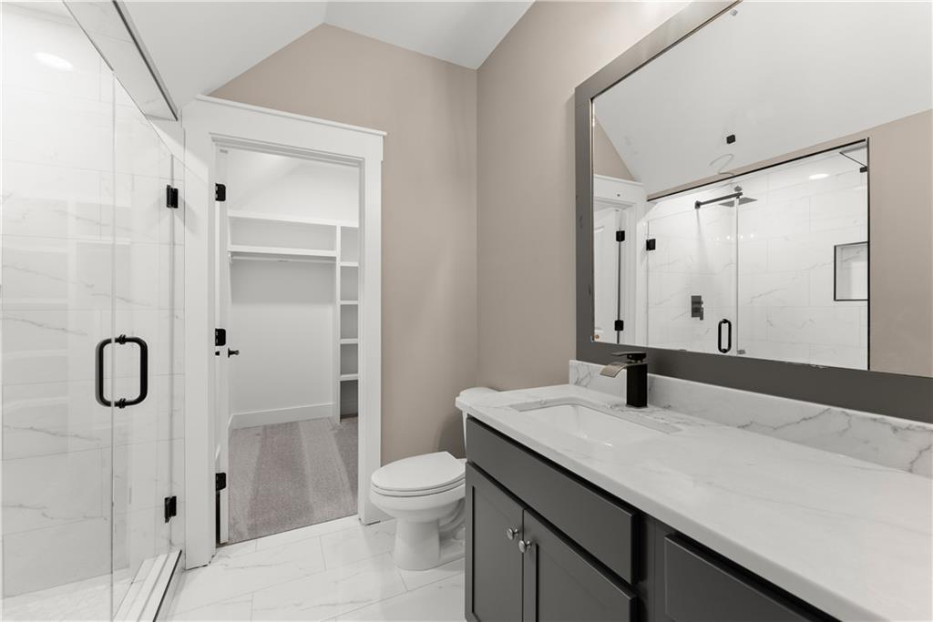 5697 Ball Ground Road Ball Ground, GA 30107 - Photo 47 of 63 a bathroom with a granite countertop sink toilet and shower