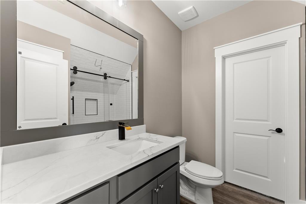 5697 Ball Ground Road Ball Ground, GA 30107 - Photo 48 of 63 a bathroom with a sink toilet and mirror