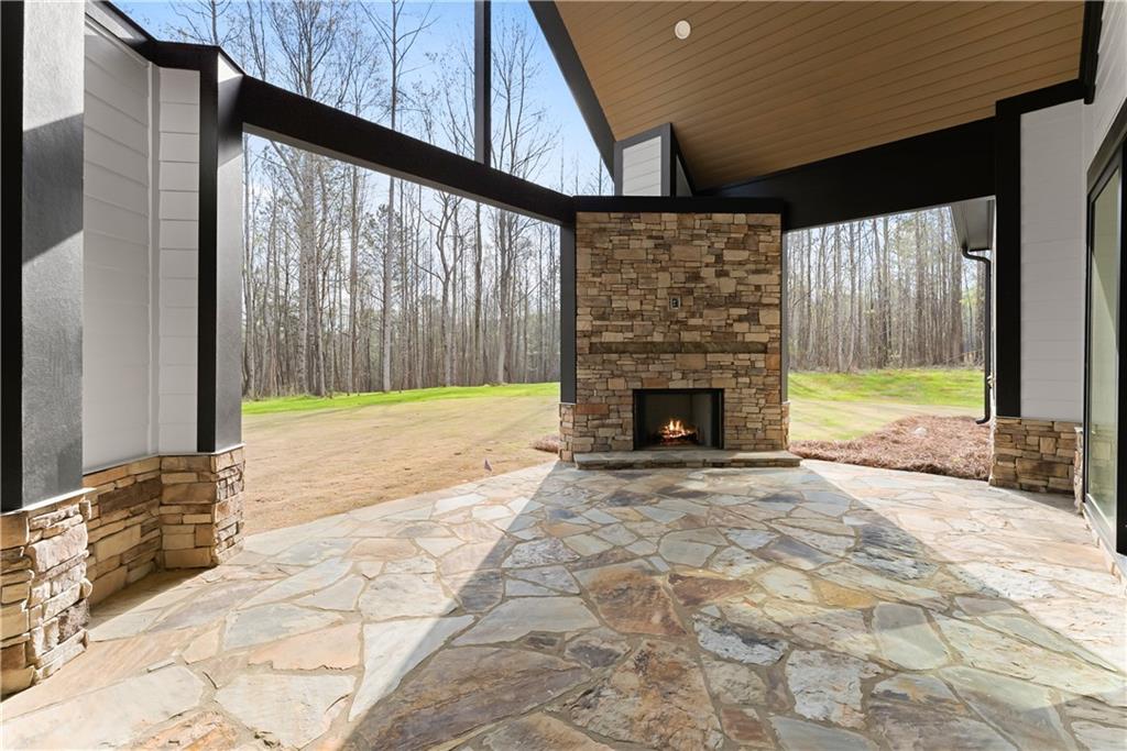 5697 Ball Ground Road Ball Ground, GA 30107 - Photo 51 of 63 a view of an empty room with a fireplace and a window