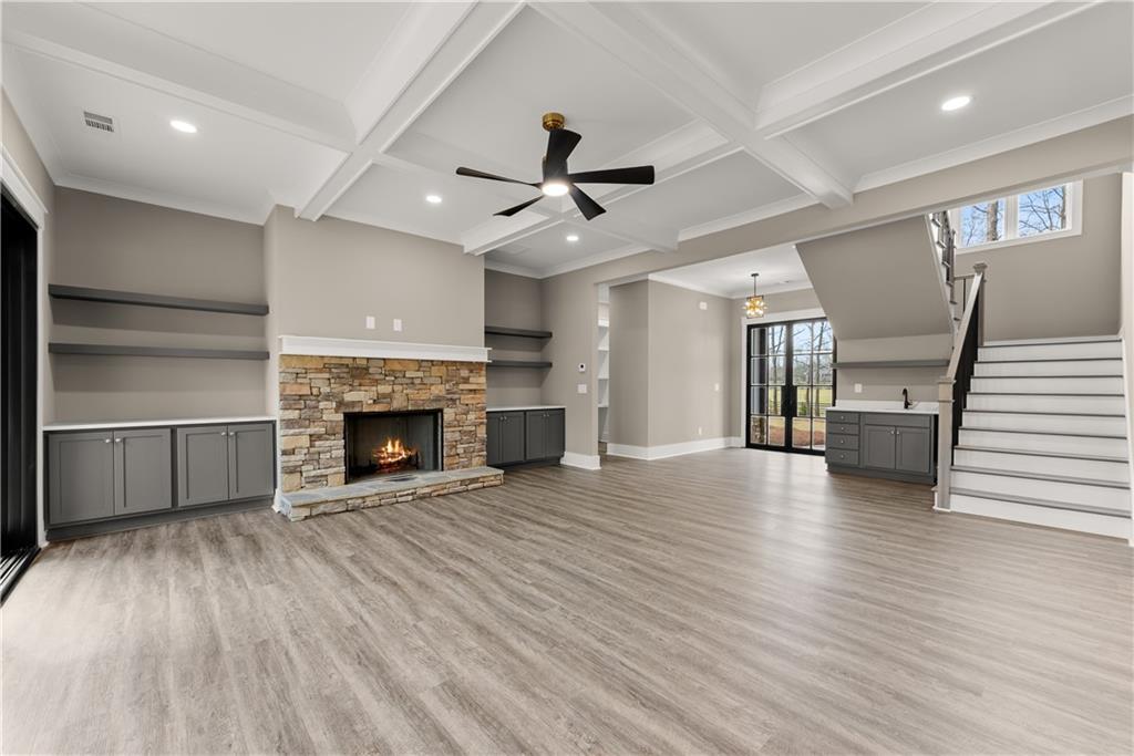 5697 Ball Ground Road Ball Ground, GA 30107 - Photo 10 of 63 a view of an empty room with wooden floor fireplace and a window